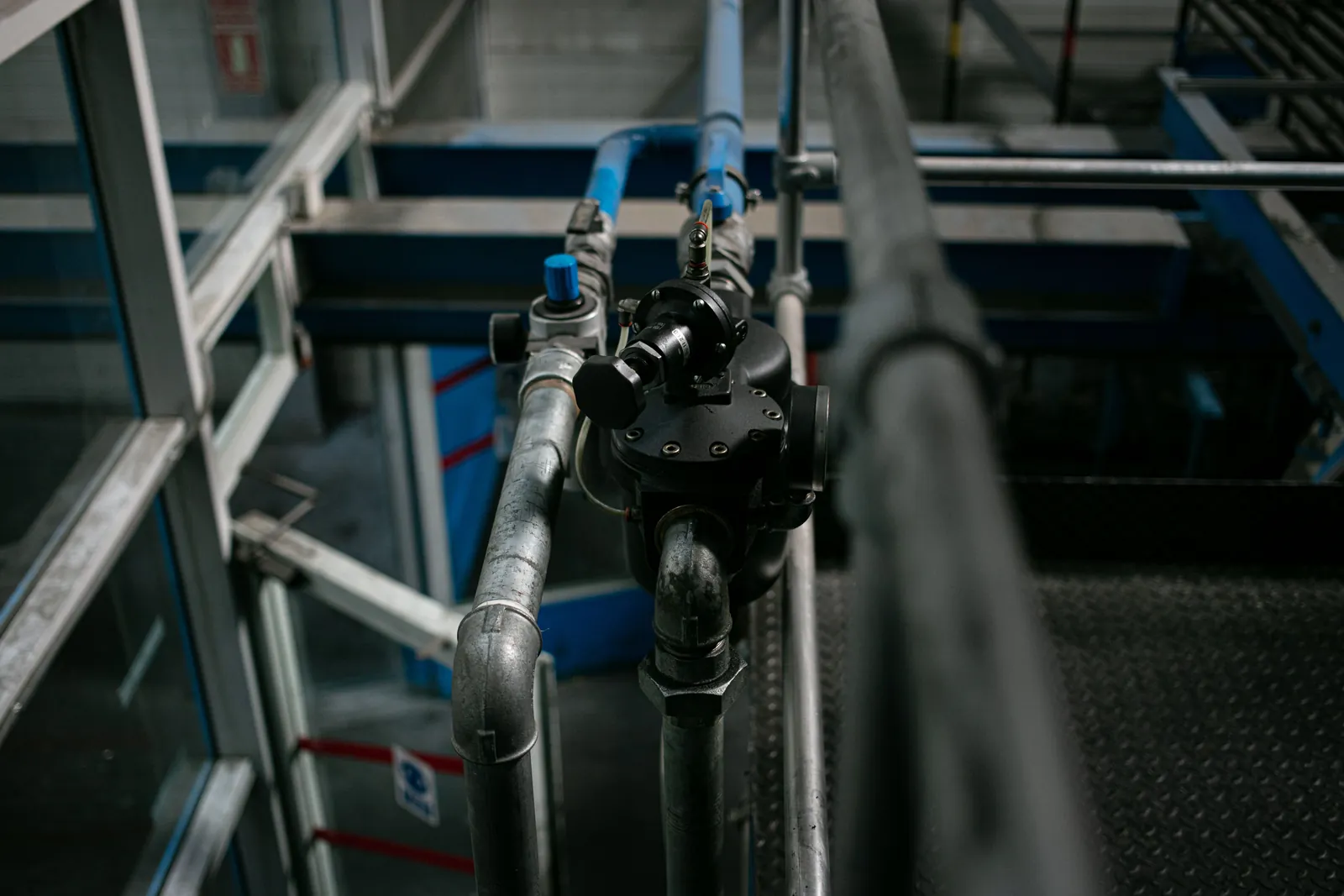 A metal pipe run fitted with shut-off valves
