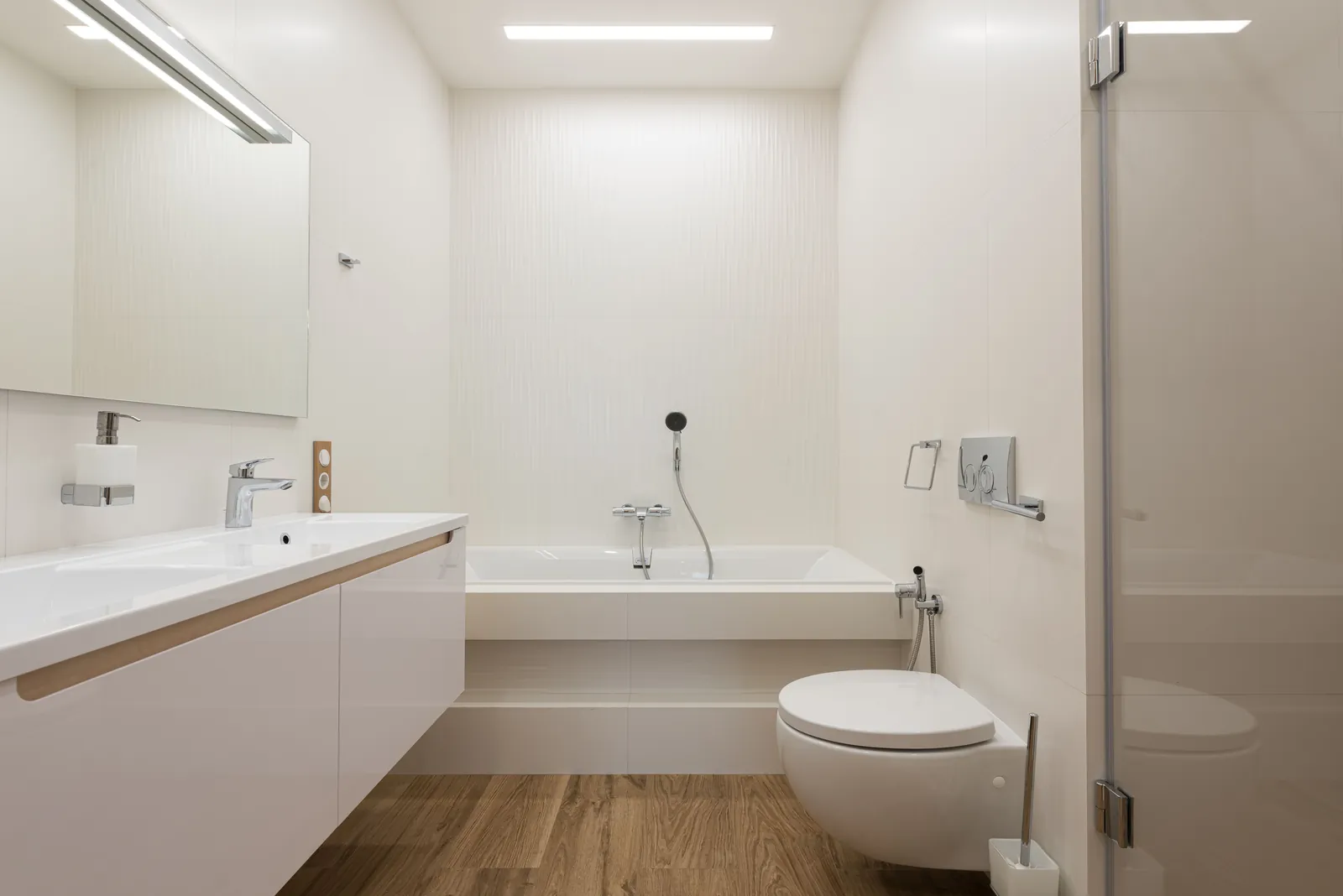 A bright modern bathroom with a white bathtub