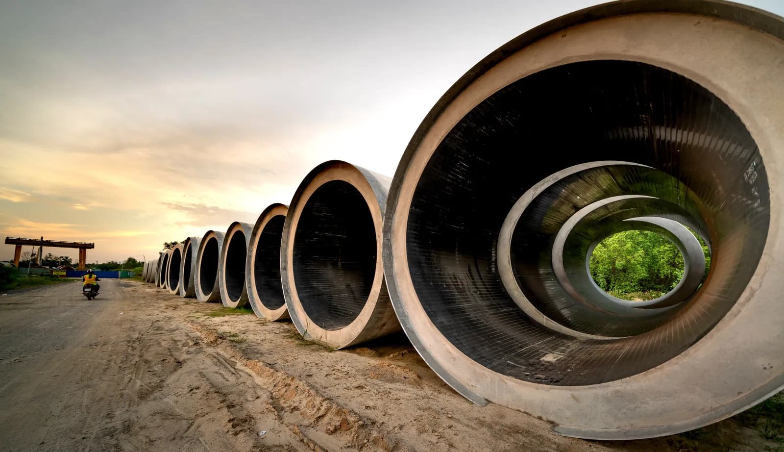 Large-diameter concrete pipe sections at a construction site