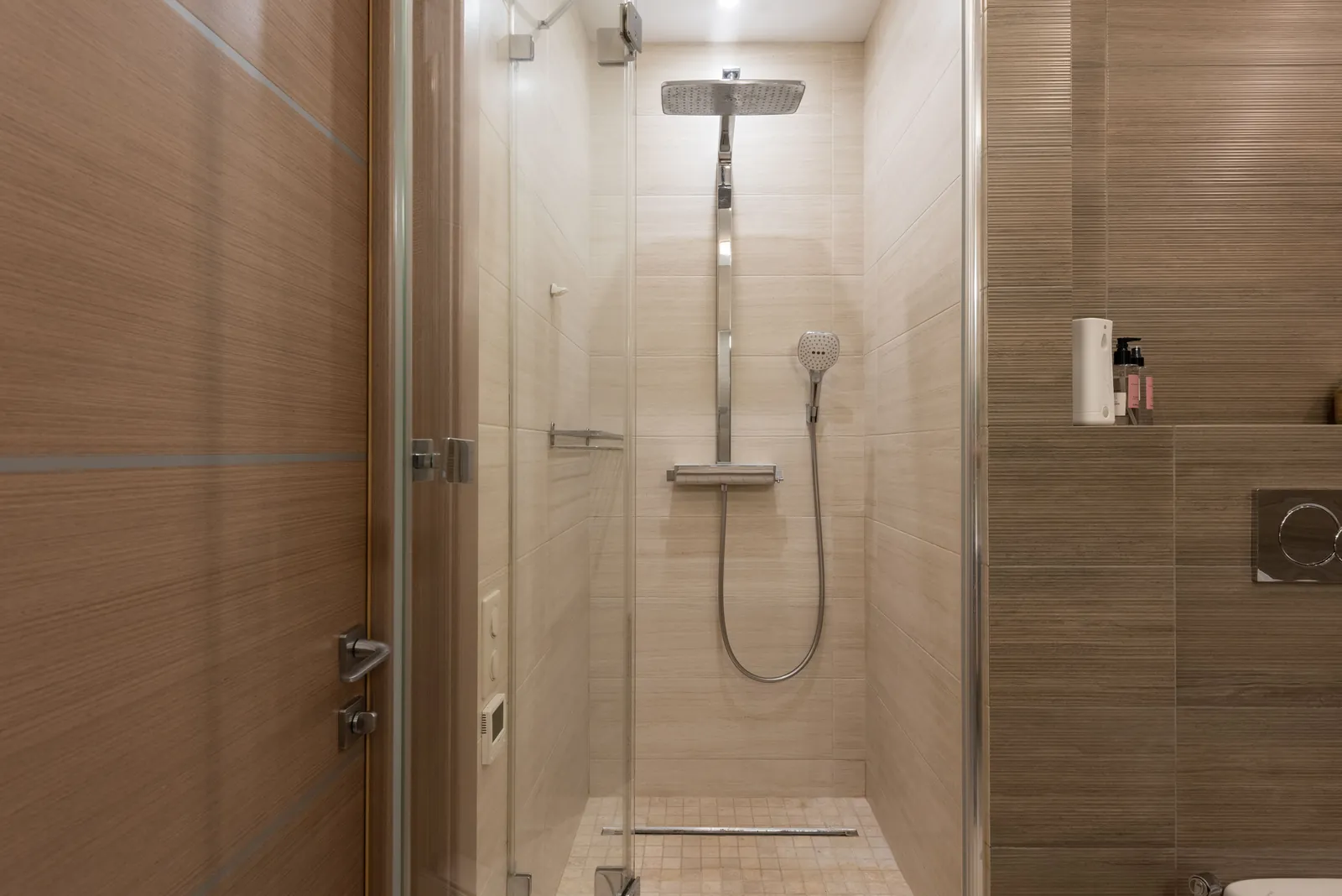 A modern shower enclosure with a glass door