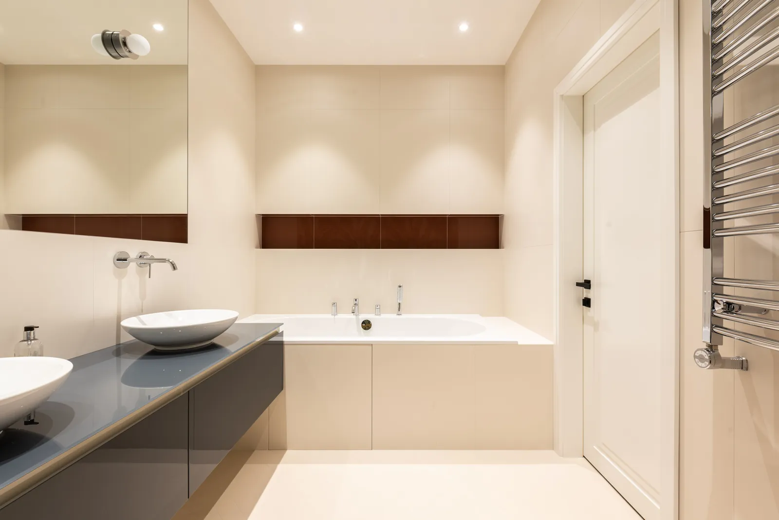 A modern bathroom with basins set on a cabinet