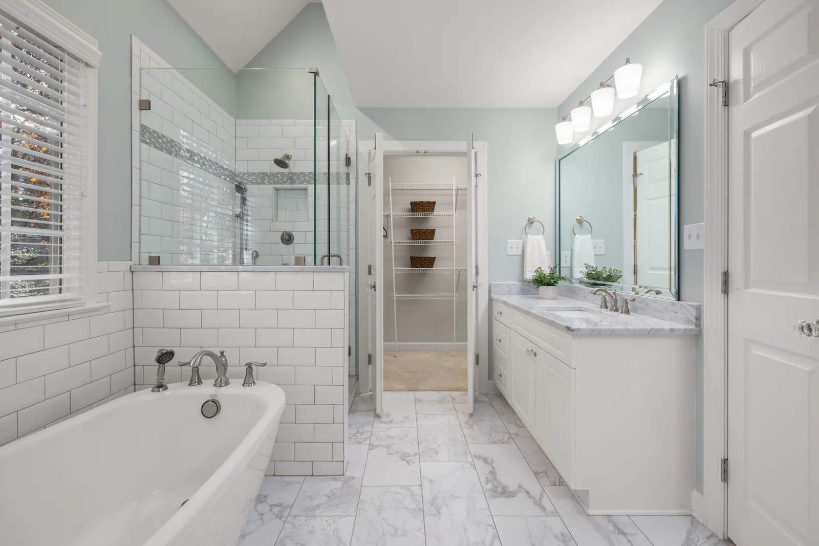 Plumbing pipe and fittings on a bare wooden subfloor during a bathroom renovation