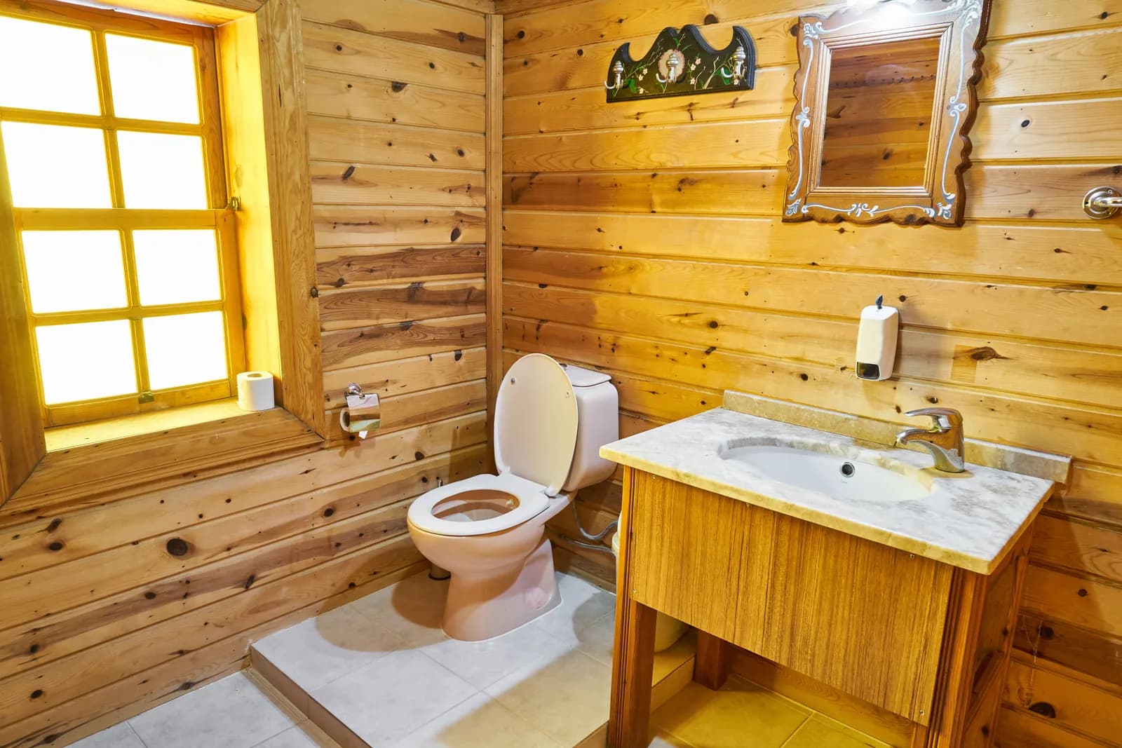 A rustic bathroom with wooden fittings and a toilet