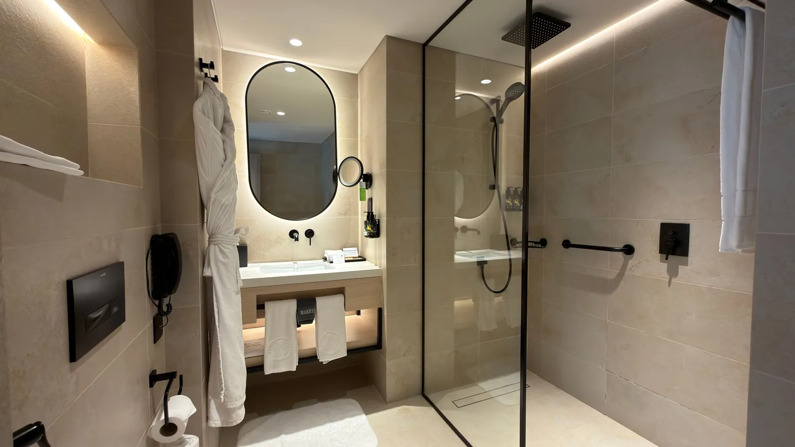 A clean hotel bathroom with a walk-in shower